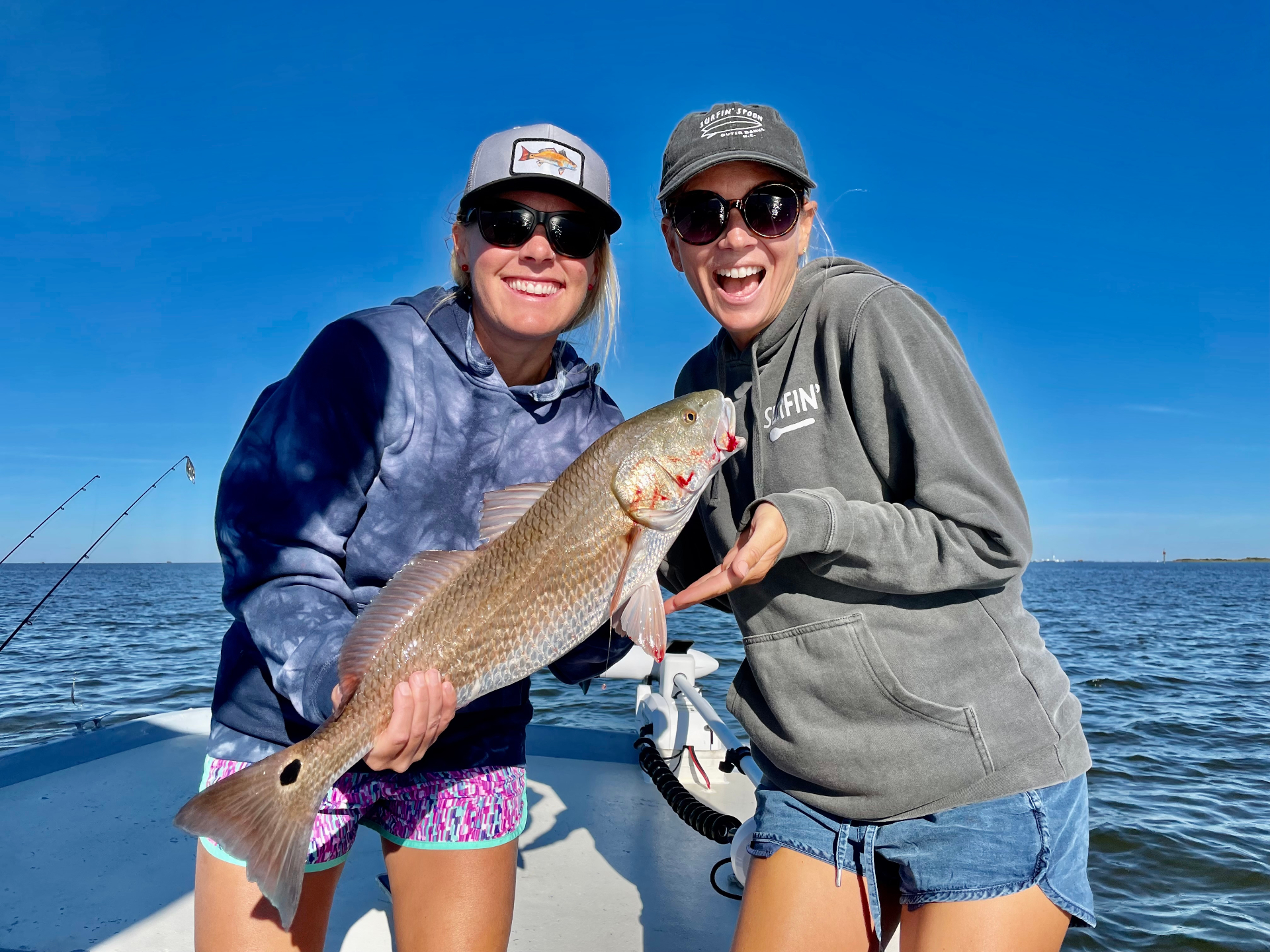 Friends celebrating a redfish catch